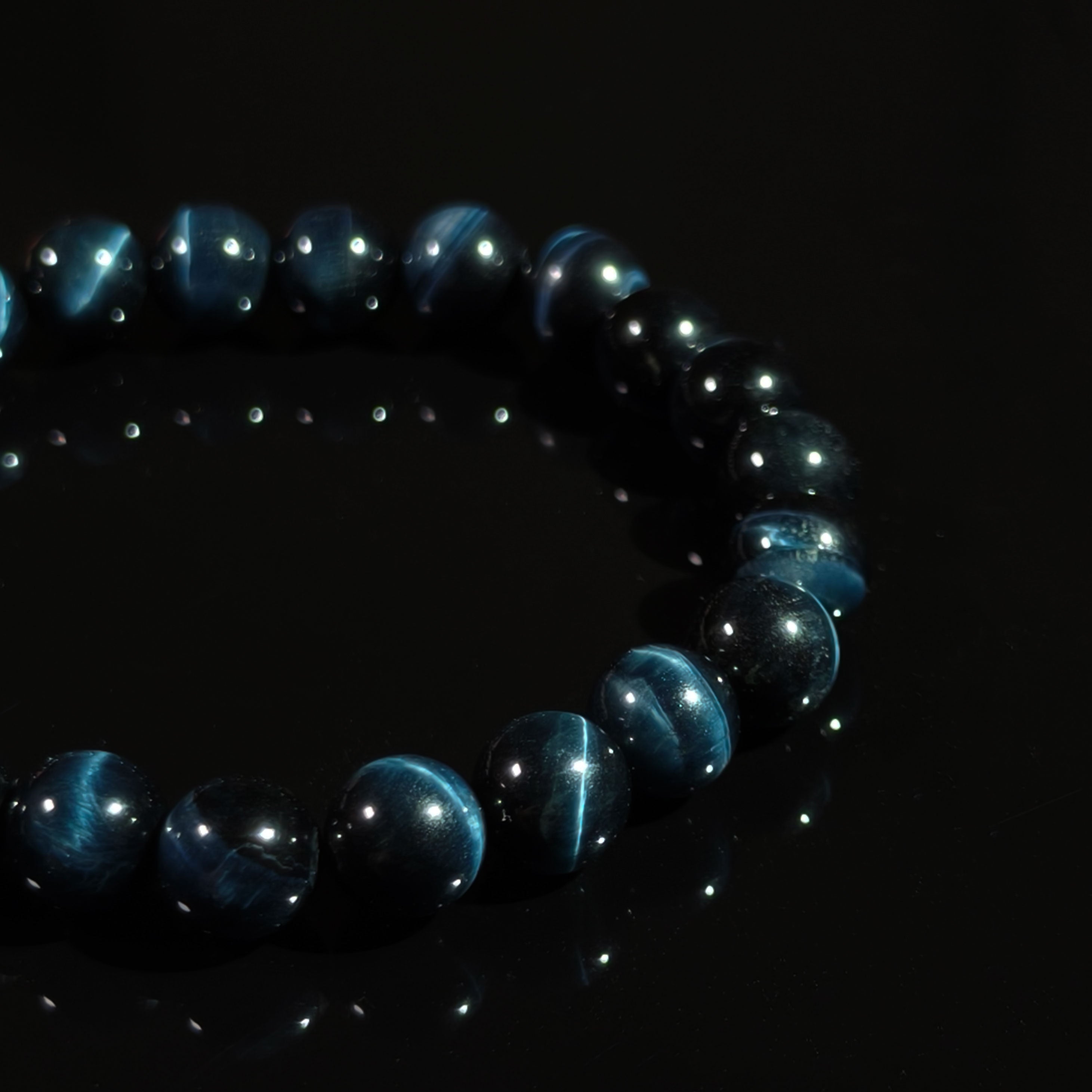 Close-up of Blue Tiger’s Eye bracelet with polished beads and natural cat’s eye shimmer.