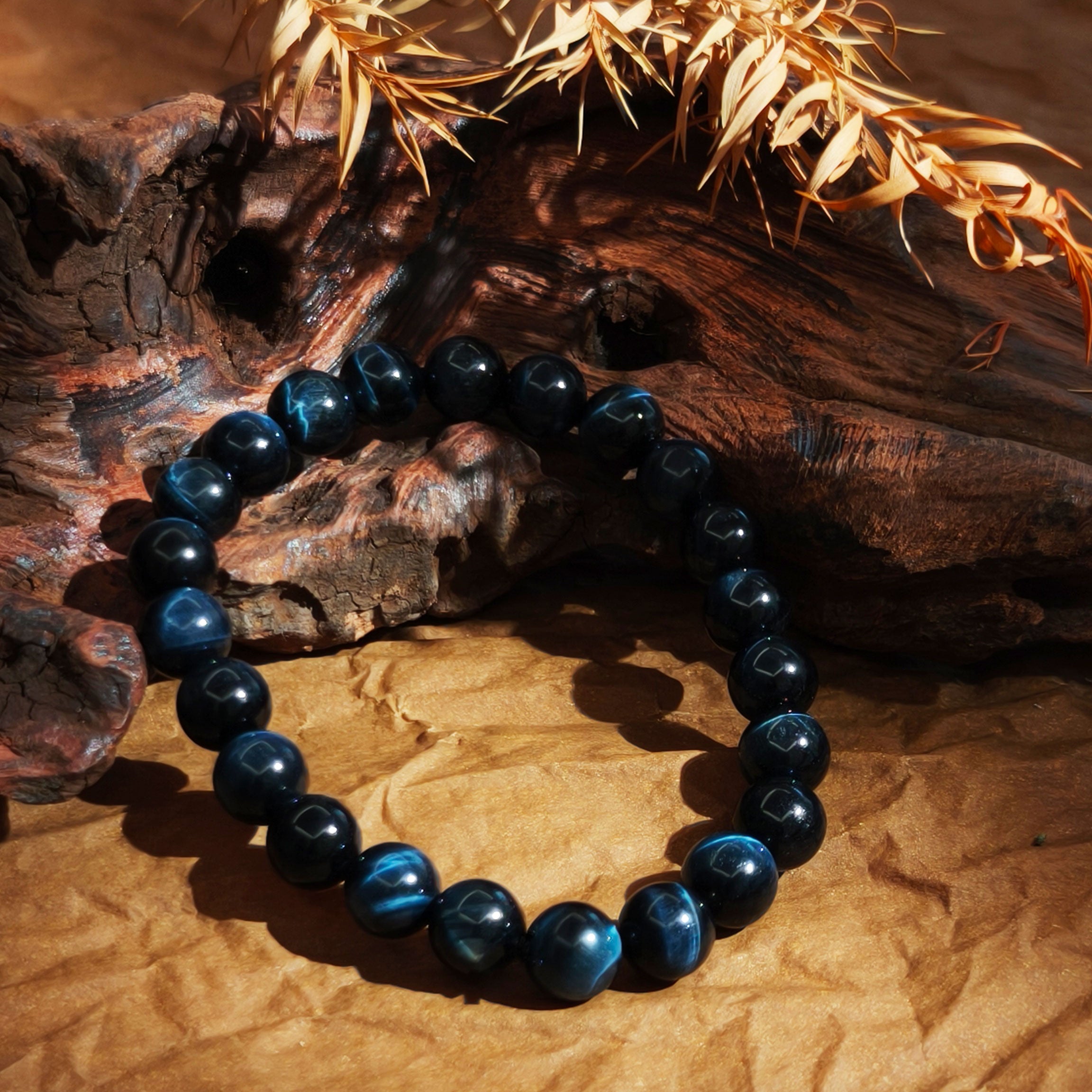 Etheris | Energy Bracelets | Blue tiger eye beaded bracelet on a wooden surface with natural light