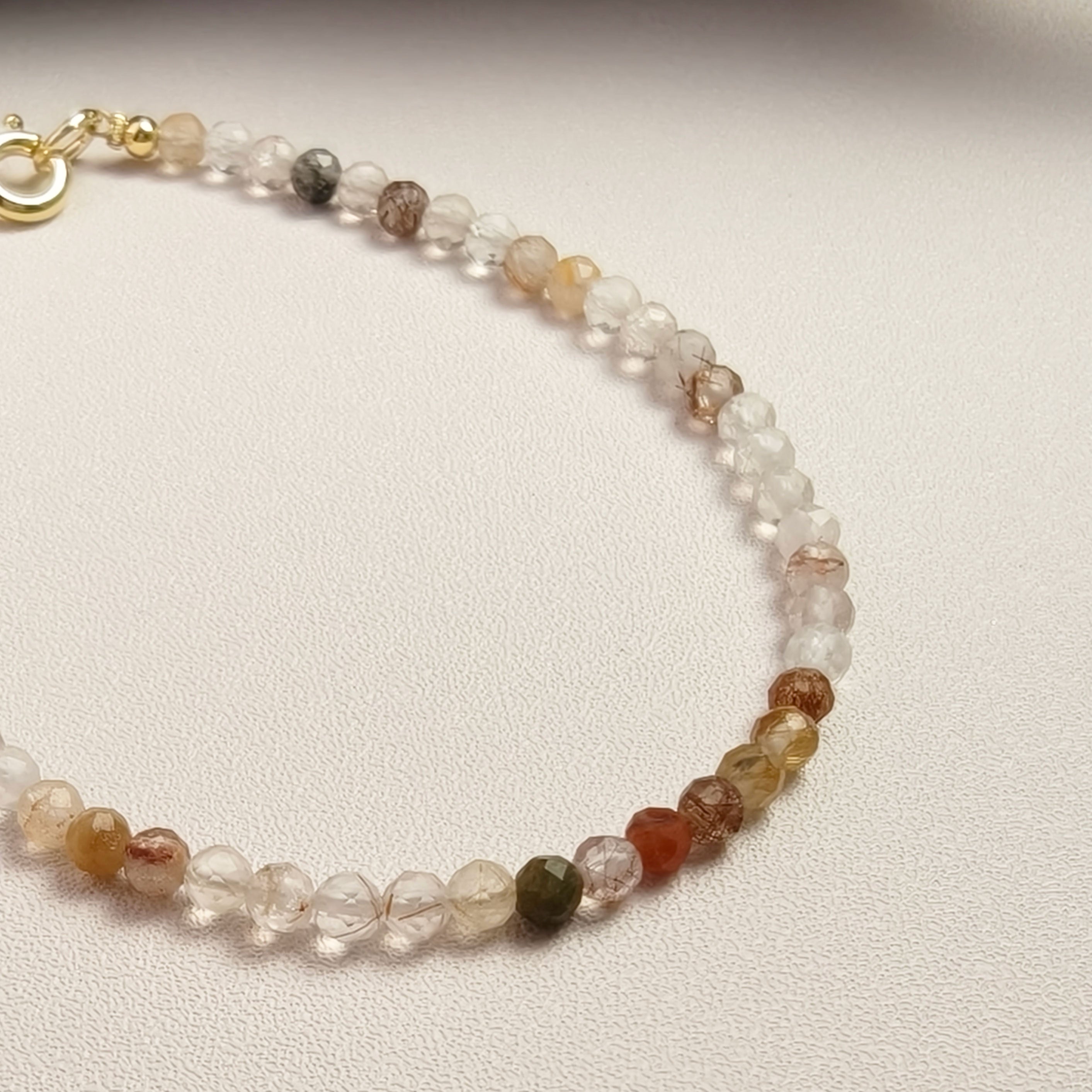 Etheris Multi-Color Rutilated Quartz Bracelet - Genuine Faceted Clear Crystal with Copper & Brown Rutile, a gemstone for prosperity and career success, inviting luck.